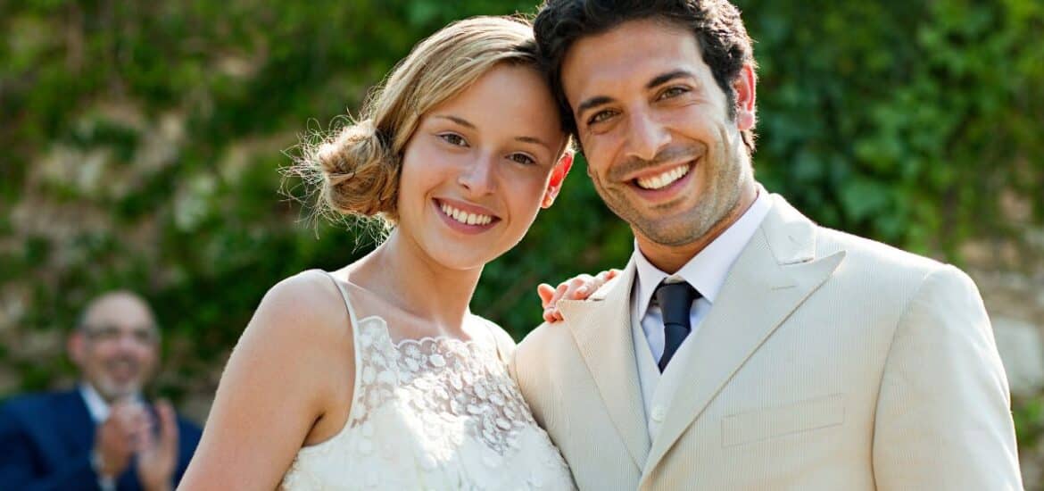 Bride and Groom smiling brightly.