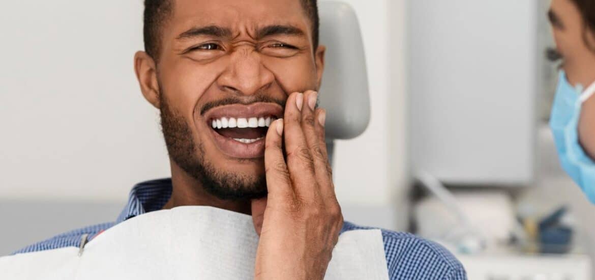 Patient with sudden tooth pain seeking an emergency dentist in Reno.