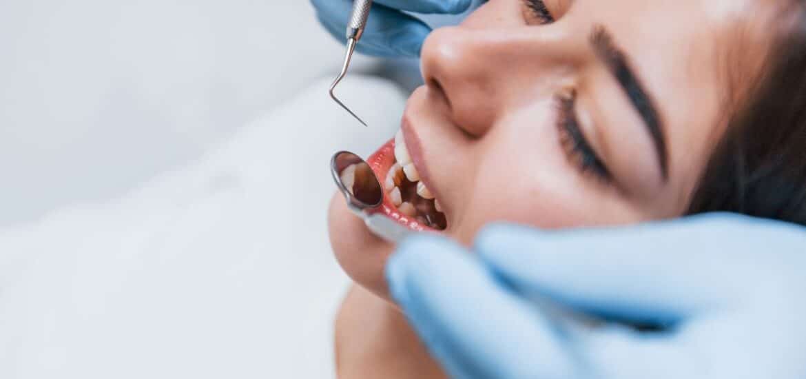 Dentist examining a patient's gums, emphasizing early detection and treatment of gum disease in Reno.