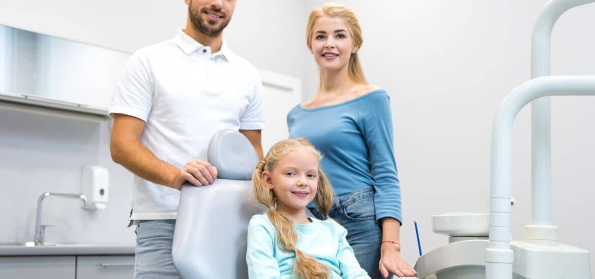 A family visiting a dental office for a routine dental cleaning.