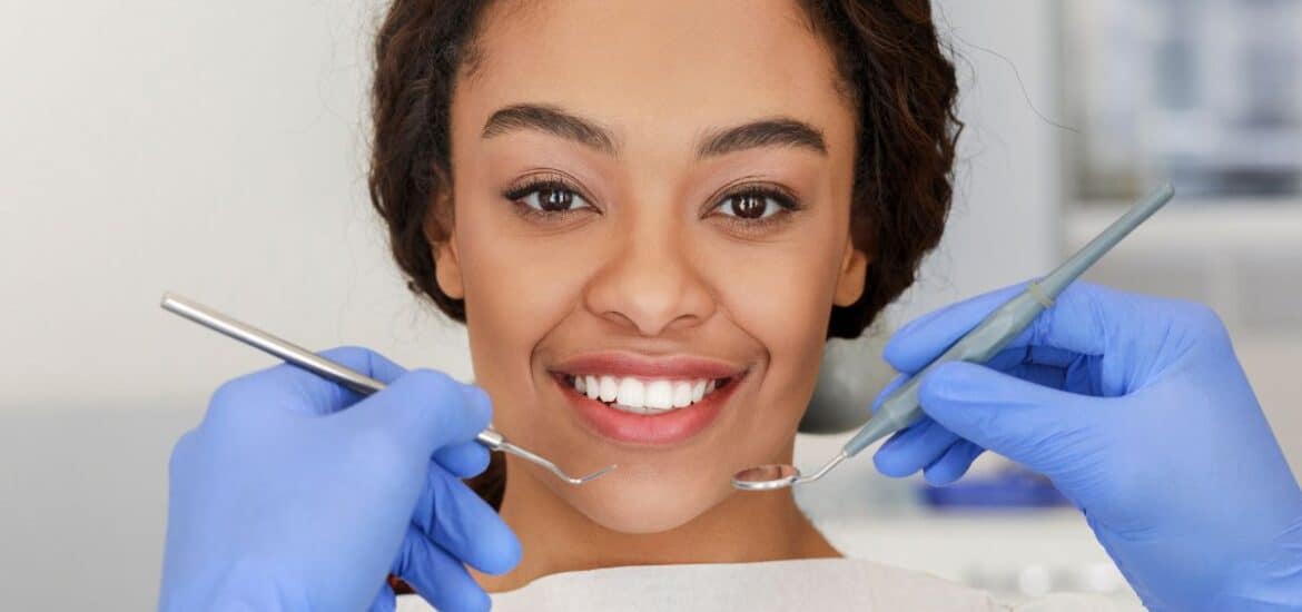 A woman smiling confidently after cosmetic dental treatment.