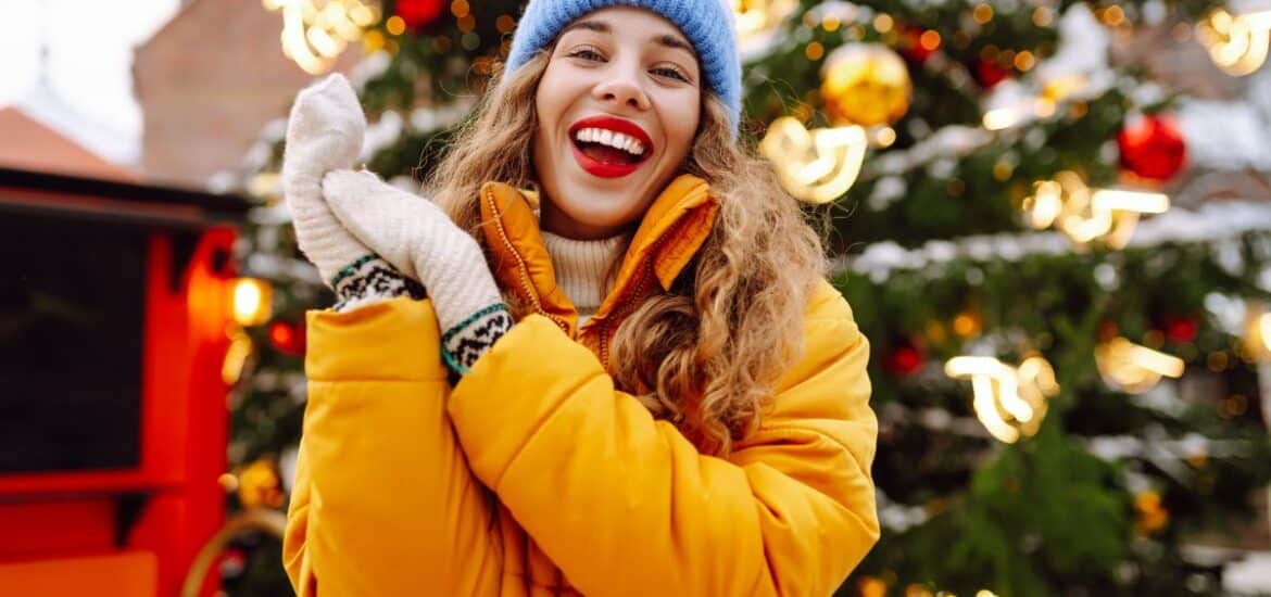 A smiling patient during Christmas celebrations, showing a fresh, healthy smile after cosmetic dentistry.