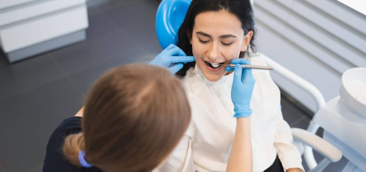 Dentist examining a patient’s teeth for overall health.
