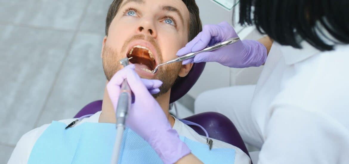 Dentist performing precise oral and facial treatment focusing on anatomy and smile aesthetics.