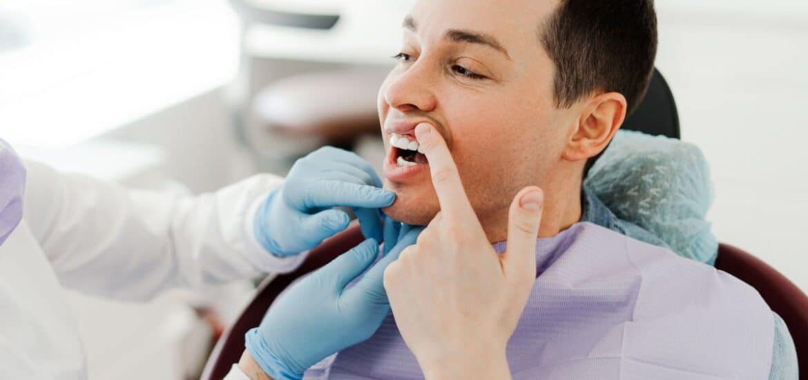 Patient discussing a dental concern during a comprehensive oral health examination.